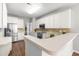 Bright kitchen with stainless appliances, tiled backsplash, and a countertop bar at 410 Willingham Rd, Morrisville, NC 27560