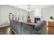 Spacious living room with decorative fireplace, gray sectional, and bright natural light at 410 Willingham Rd, Morrisville, NC 27560
