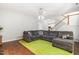 Bright living room with staircase, large gray sectional and verdant area rug at 410 Willingham Rd, Morrisville, NC 27560