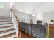 Cozy living room featuring a fireplace, gray sofa, hardwood floors, and a staircase at 410 Willingham Rd, Morrisville, NC 27560