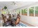 Sunny sun room with lots of windows, chairs and table at 410 Willingham Rd, Morrisville, NC 27560