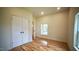Bright bedroom with hardwood floors, white trim and a window, featuring a large closet at 416 Everett St, Burlington, NC 27215