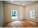 Bright bedroom featuring hardwood floors, white trim and two windows providing natural light at 416 Everett St, Burlington, NC 27215
