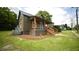 Side view of home shows metal roof, covered porch, and green siding at 416 Everett St, Burlington, NC 27215