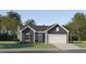 Charming single-story home featuring a well-manicured lawn, two-car garage, and inviting gray color palette at 43 Playtime Cir, Princeton, NC 27569