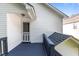 Low angle shows a back porch with a screen door, white siding and trim and blue painted deck at 4505 Woodlawn Dr, Raleigh, NC 27616