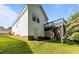 Exterior view of home showing the back yard, back door and raised wooden deck with stairs at 4505 Woodlawn Dr, Raleigh, NC 27616
