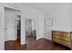 Bedroom with hardwood floors and ensuite with a view into the bathroom at 4505 Woodlawn Dr, Raleigh, NC 27616