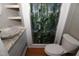 Updated bathroom featuring a unique vessel sink, granite countertop, and walk-in shower at 521 S Lombard St, Clayton, NC 27520