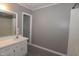 Bathroom showcasing updated vanity, neutral paint color, and mirror at 521 S Lombard St, Clayton, NC 27520