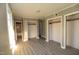 Bedroom featuring hardwood flooring, three closets, and neutral paint at 521 S Lombard St, Clayton, NC 27520