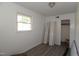 Bedroom with window, hardwood flooring, closet doors, and neutral paint at 521 S Lombard St, Clayton, NC 27520