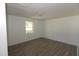 Bright bedroom with durable wood-look flooring and a view of the outdoor area at 521 S Lombard St, Clayton, NC 27520