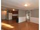 Open-concept dining area with hardwood floors, connecting the kitchen and laundry area at 521 S Lombard St, Clayton, NC 27520