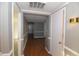 Hallway with hardwood flooring showcasing multiple doorways and an open layout at 521 S Lombard St, Clayton, NC 27520