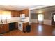 Bright kitchen with wood cabinets, laminate counters, open to adjacent dining area at 521 S Lombard St, Clayton, NC 27520