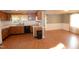 Spacious eat-in kitchen with hardwood floors and open layout to the dining area at 521 S Lombard St, Clayton, NC 27520