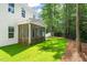 Landscaped backyard with lawn, trees, and screened-in porch at 525 Kings Lake Way, Durham, NC 27703