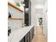 Bar area features sleek black cabinetry, stainless beverage cooler, and light countertops for a sophisticated touch at 525 Kings Lake Way, Durham, NC 27703