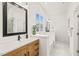 Stylish bathroom features custom wood vanity, contemporary fixtures, and a soaking tub at 525 Kings Lake Way, Durham, NC 27703