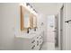 Bright bathroom boasts dual sinks, wood-framed mirrors, and sleek black fixtures at 525 Kings Lake Way, Durham, NC 27703