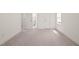 Empty bedroom with neutral carpeting, and two doorways provides a blank canvas at 525 Kings Lake Way, Durham, NC 27703