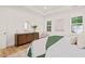 Relaxing bedroom with hardwood floors features a decorative dresser and natural light at 525 Kings Lake Way, Durham, NC 27703