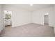 Carpeted bedroom featuring a vanity and an open door to a closet at 525 Kings Lake Way, Durham, NC 27703