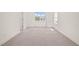 Bright, carpeted bedroom with natural light streaming through the windows at 525 Kings Lake Way, Durham, NC 27703