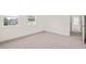A neutral carpeted bedroom bathed in sunlight from multiple windows at 525 Kings Lake Way, Durham, NC 27703