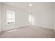 Unfurnished bedroom features plush carpeting, two windows, and neutral paint at 525 Kings Lake Way, Durham, NC 27703
