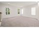 Bright carpeted bedroom with multiple windows allowing natural light at 525 Kings Lake Way, Durham, NC 27703