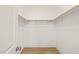 Walk-in closet with wood flooring has ample storage and open shelving at 525 Kings Lake Way, Durham, NC 27703