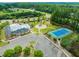 Aerial view showcasing community amenities including a pool, playground, tennis court, and parking at 525 Kings Lake Way, Durham, NC 27703