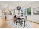 Dining room features an open layout with a modern light fixture and an eat-in kitchen at 525 Kings Lake Way, Durham, NC 27703