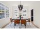 Cozy dining room with modern accents, seating for six, and a view of the neighborhood at 525 Kings Lake Way, Durham, NC 27703