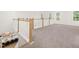 Bright hallway with carpet and railing overlooking the kitchen with island and barstool seating at 525 Kings Lake Way, Durham, NC 27703