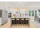 Stylish kitchen island featuring barstool seating, stainless appliances, and natural lighting at 525 Kings Lake Way, Durham, NC 27703
