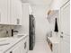 Modern laundry room featuring ample cabinet space, sink, and stacked washer/dryer at 525 Kings Lake Way, Durham, NC 27703
