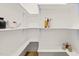 Walk-in pantry features custom shelving perfect for ample storage space at 525 Kings Lake Way, Durham, NC 27703
