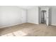 A large bedroom with carpet and a view into the hallway and closet at 5309 Neuse Wood Dr, Raleigh, NC 27616
