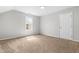 Neutral bedroom featuring a window for natural light and carpet at 5309 Neuse Wood Dr, Raleigh, NC 27616