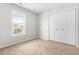 Neutral bedroom featuring a window for natural light and a large closet at 5309 Neuse Wood Dr, Raleigh, NC 27616