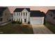 Charming two-story home with attached two-car garage, well-maintained lawn, and manicured shrubbery at 5309 Neuse Wood Dr, Raleigh, NC 27616