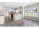 Open-concept kitchen flows seamlessly into the living area, featuring white cabinets and modern appliances at 5309 Neuse Wood Dr, Raleigh, NC 27616