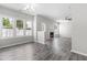 Bright living room features laminate flooring, multiple windows, and a cozy fireplace at 5309 Neuse Wood Dr, Raleigh, NC 27616
