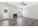 Bright living room featuring a cozy fireplace and durable gray wood-look flooring at 5309 Neuse Wood Dr, Raleigh, NC 27616