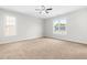 Spacious main bedroom with windows offering natural light and a plush carpet at 5309 Neuse Wood Dr, Raleigh, NC 27616