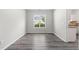 A versatile room features laminate flooring, a large window, and neutral walls, ready for personalization at 5309 Neuse Wood Dr, Raleigh, NC 27616