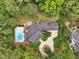 Aerial view of the property featuring a pool, expansive backyard, patio, and well-manicured landscaping at 5317 Moonflower Ct, Holly Springs, NC 27540